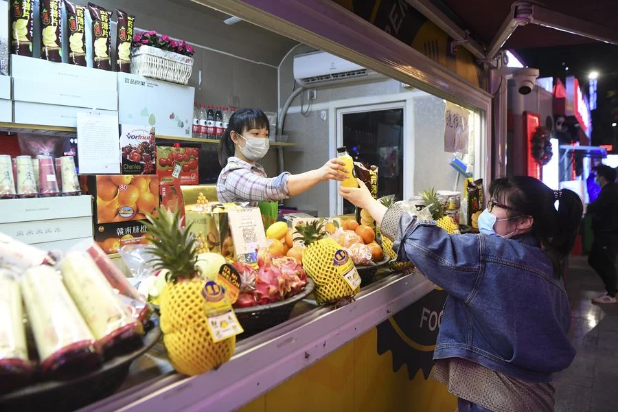 A customer purchases beverage in Jiangbei District of Chongqing, southwest China, March 23, 2020.
