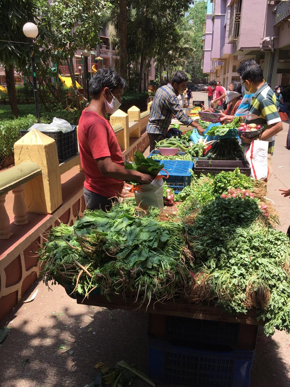 In pics: Residents practice social distancing as societies arrange for vegetable vendors