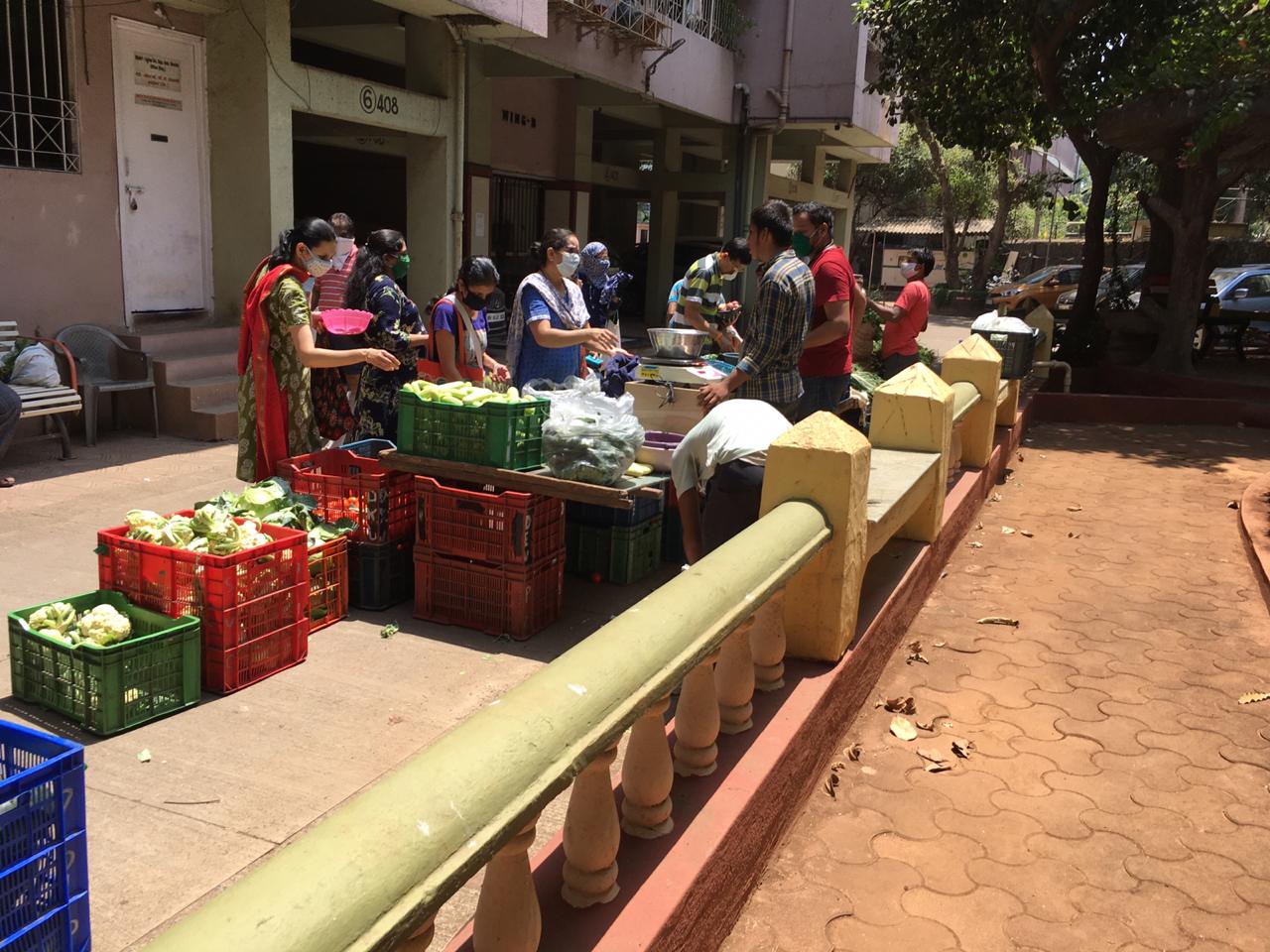 In pics: Residents practice social distancing as societies arrange for vegetable vendors