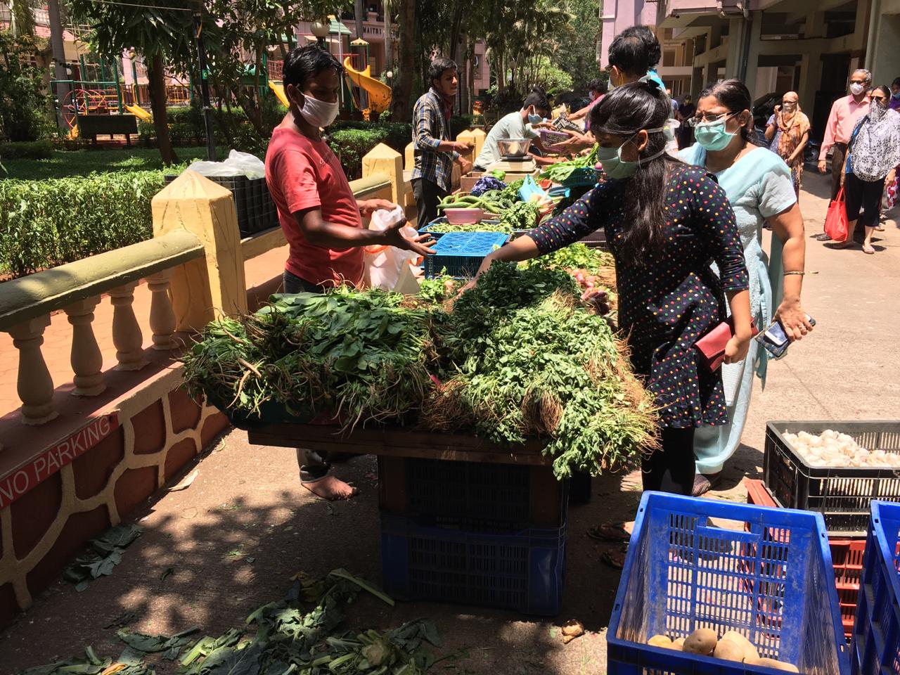 In pics: Residents practice social distancing as societies arrange for vegetable vendors