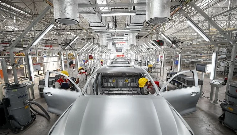 Workers are seen at a factory of Great Wall Motors in Yongchuan District of Chongqing, southwest China, March 18, 2020.