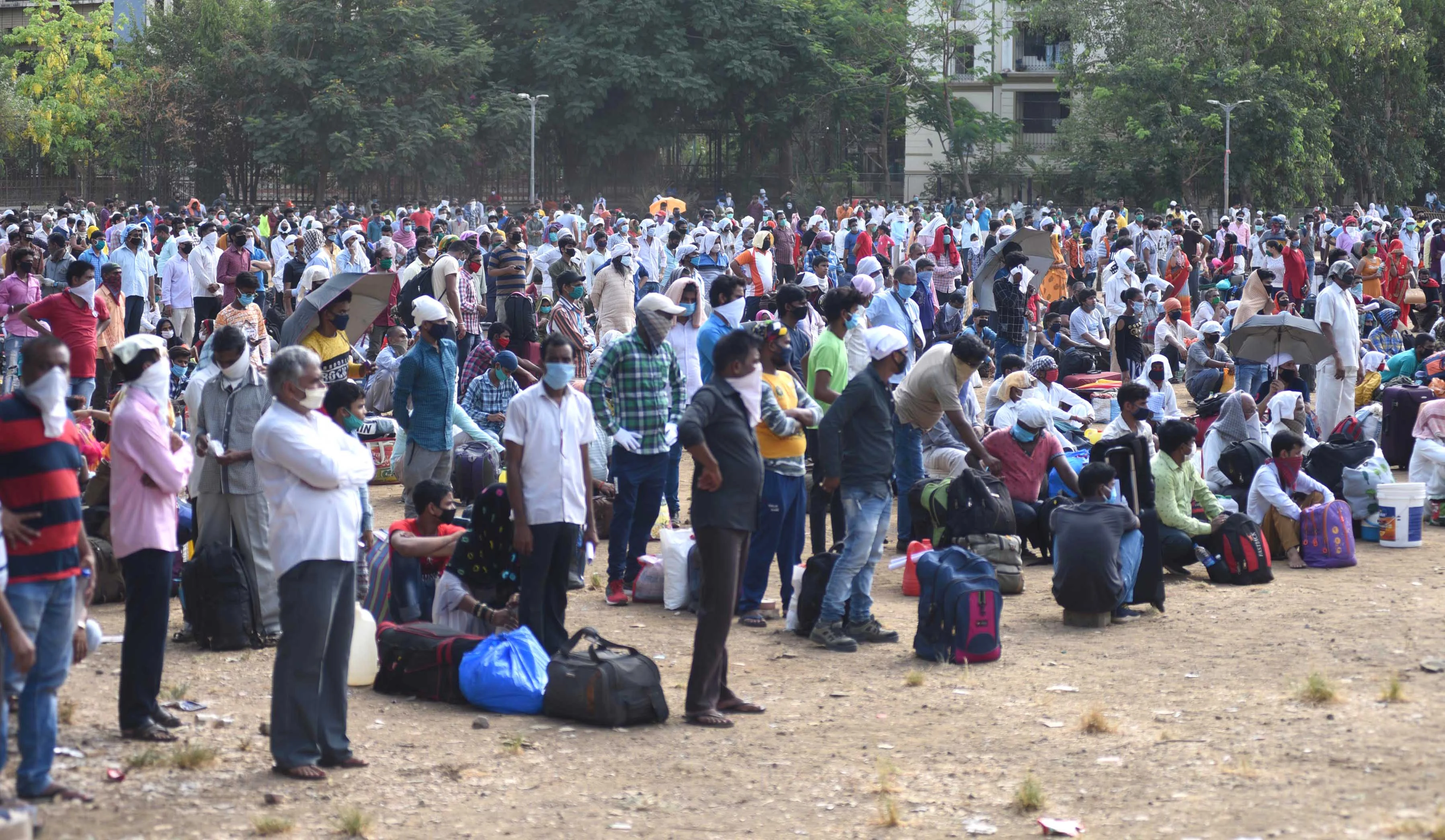 Long way home: Migrants queue for train tickets at Mumbai