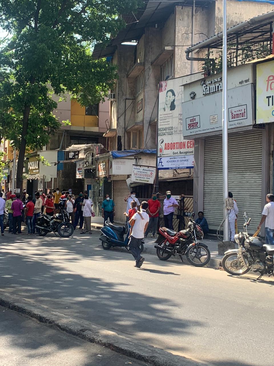 Tipplers at Thane's famous Gokhale Road queue up to anxiously wait for the opening of liquor shop and its purchase