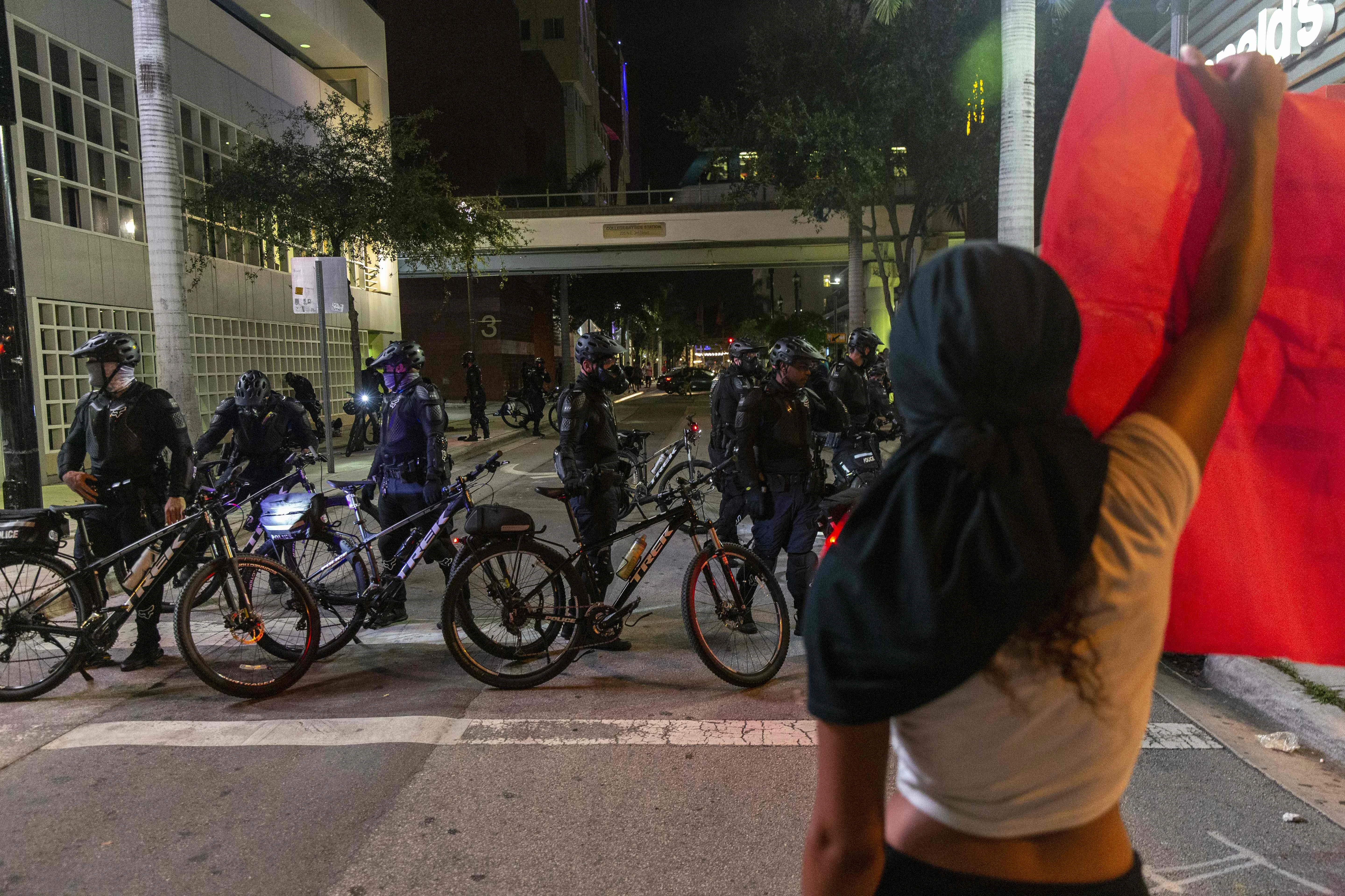 A woman holds a protest banner in Florida, USA