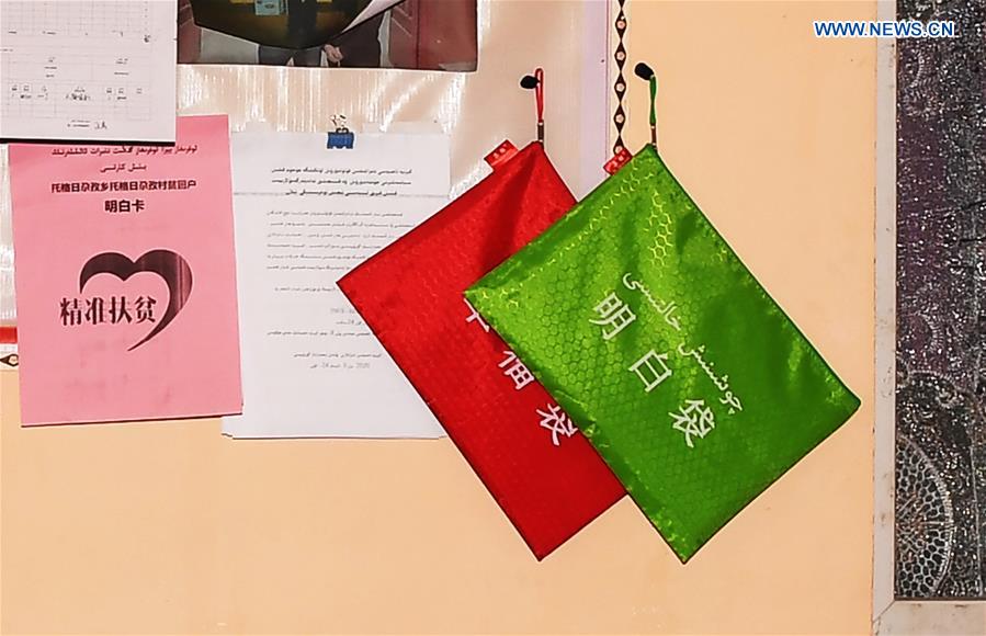 Photo taken on May 22, 2020 shows a bag containing records of information about the family members, contracted land, livestock and income hanging on the wall in a villager's house in Togragaz Township of Hotan Prefecture, northwest China's Xinjiang Uygur Autonomous Region.