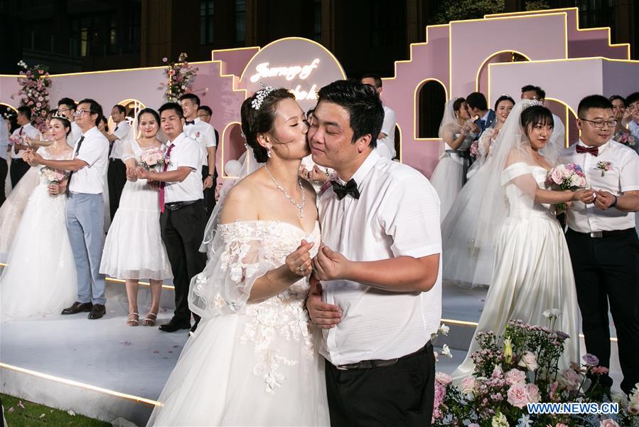 Newly-married couples attend a group wedding ceremony in Boao, south China's Hainan Province, June 6, 2020. A group wedding ceremony was held here on Saturday for 30 newly-married couples from Beijing, Wuhan, Guangzhou among others. Some of the newly married people's wedding ceremonies had been postponed by their work in the fight against coronavirus outbreak in Hubei Province.