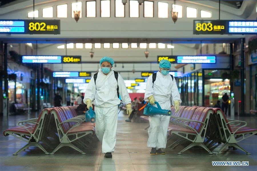 Staff members disinfect a waiting room of Beijing Railway Station in Beijing, capital of China, June 18, 2020. Following the upgrade of emergency response to COVID-19 from Level III to Level II in Beijing, Beijing Railway Station has conducted strict measures to prevent and control the spread of the epidemic.
