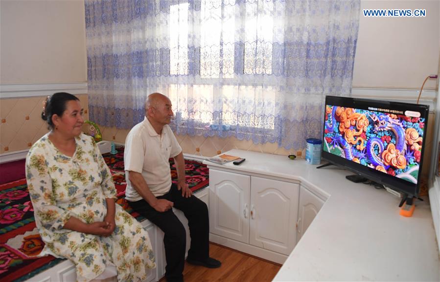 Villagers watch TV at their house in Kokyar Township of Yutian County in Hotan Prefecture, northwest China's Xinjiang Uygur Autonomous Region, May 21, 2020.