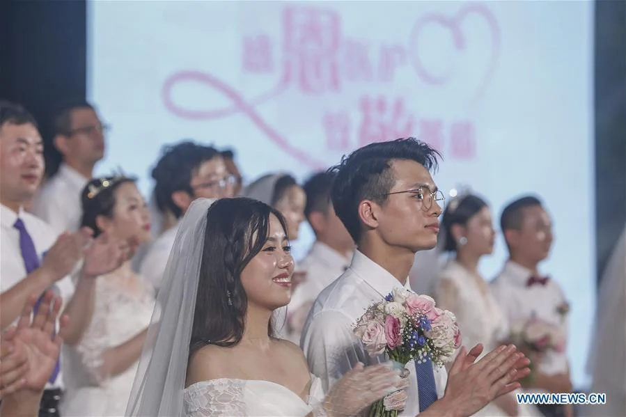 Newly-married couples attend a group wedding ceremony in Boao, south China's Hainan Province, June 6, 2020. A group wedding ceremony was held here on Saturday for 30 newly-married couples from Beijing, Wuhan, Guangzhou among others. Some of the newly married people's wedding ceremonies had been postponed by their work in the fight against coronavirus outbreak in Hubei Province.
