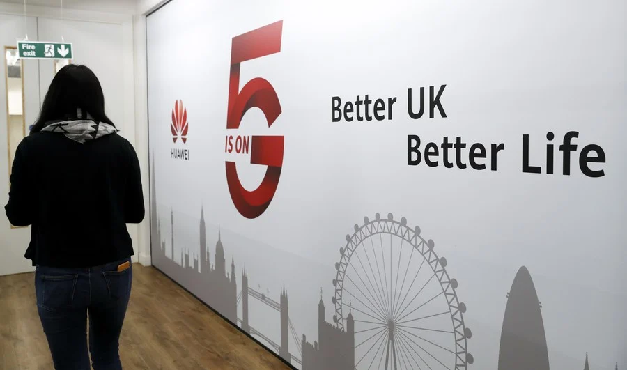 A staff member walks past Huawei 5G Innovation and Experience Center in London, Britain, on Jan. 28, 2020.