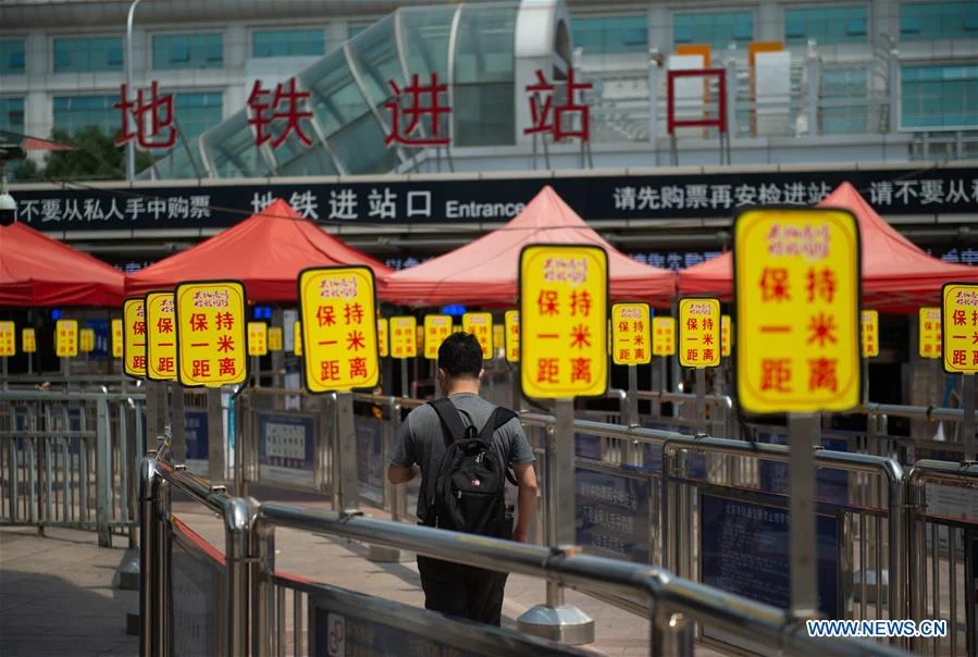 A passenger walks to an entrance of the subway at Beijing Railway Station in Beijing, capital of China, June 18, 2020. Following the upgrade of emergency response to COVID-19 from Level III to Level II in Beijing, Beijing Railway Station has conducted strict measures to prevent and control the spread of the epidemic.