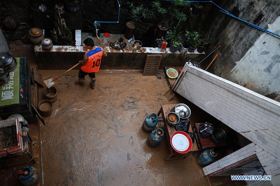 A resident cleans silt at his home in Bifeng Town of Zheng'an County in Zunyi, southwest China's Guizhou Province, June 13, 2020. Rain-triggered floods have affected more than 700,000 people in southwest China's Guizhou Province, with 29,500 individuals temporarily evacuated, authorities said Saturday.