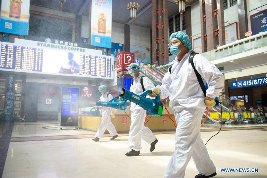 Staff members disinfect the hall of Beijing Railway Station in Beijing, capital of China, June 18, 2020. Following the upgrade of emergency response to COVID-19 from Level III to Level II in Beijing, Beijing Railway Station has conducted strict measures to prevent and control the spread of the epidemic.