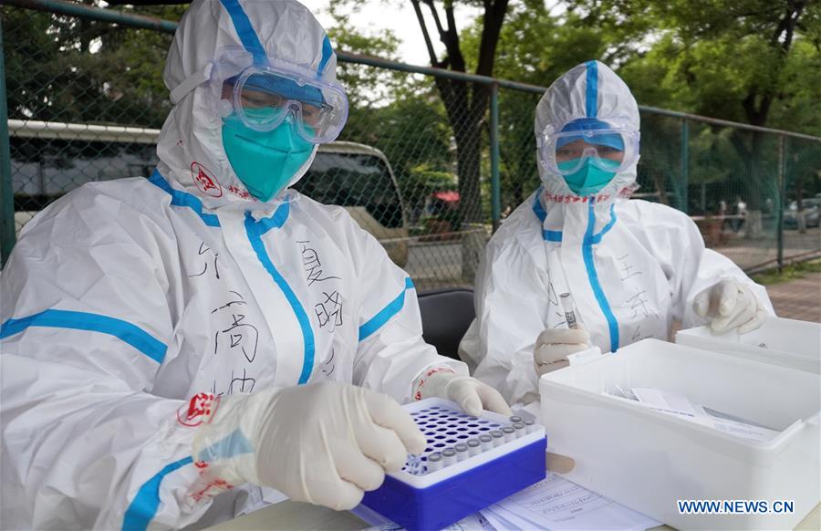 Medical workers collect samples for nucleic acid tests at a sampling site in Fengtai District of Beijing, capital of China, June 15, 2020. Beijing on Sunday conducted nucleic acid tests on 76,499 people, with 59 testing positive for COVID-19, according to a press conference held Monday. As of 6 a.m. Monday, 193 sampling sites had been set up across Beijing to facilitate nucleic acid testings, said Gao Xiaojun, spokesperson for the municipal health commission.