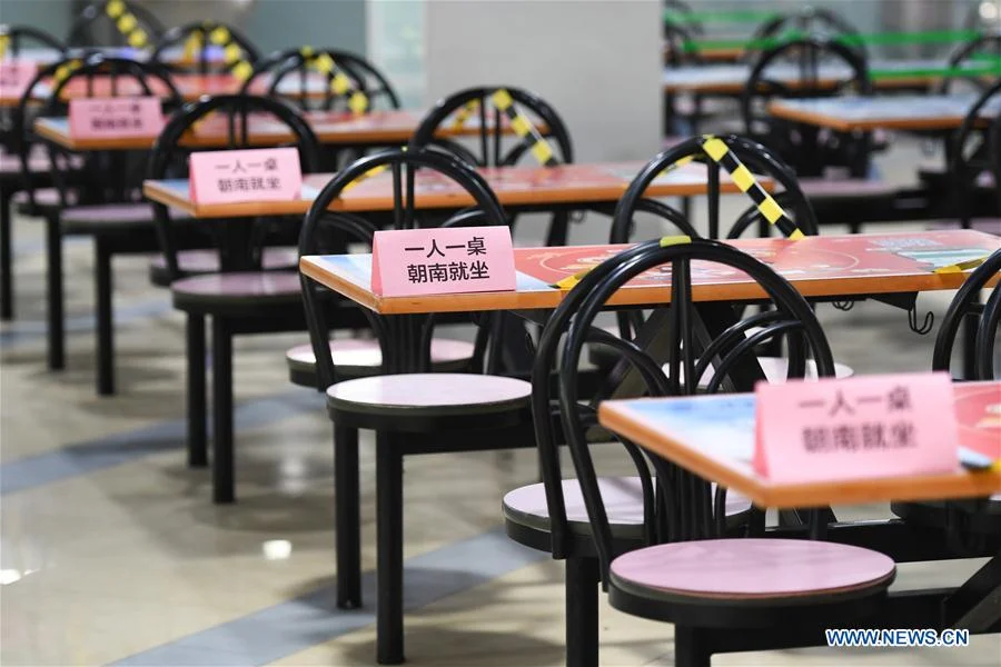 Photo taken on June 6, 2020 shows signs reminding students of social distancing at a canteen in Tsinghua University in Beijing, capital of China.