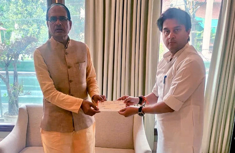 BJP leader Jyotiraditya Scindia meets Madhya Pradesh Chief Minister Shivraj Singh Chouhan and handover a relief cheque for COVID19 fund, New Delhi on Monday.