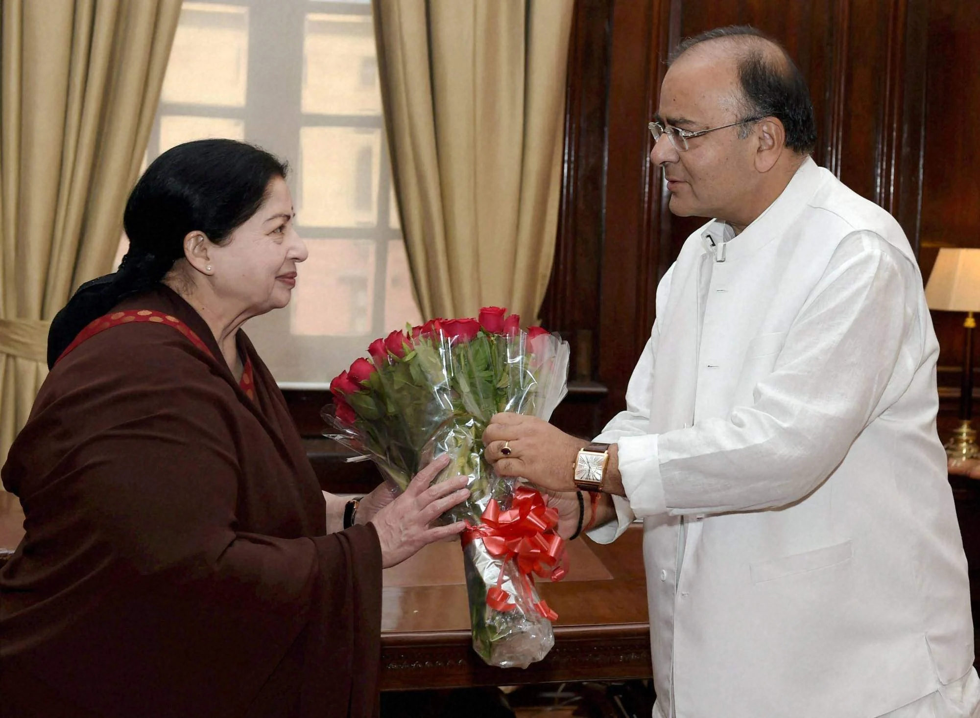 Tamil Nadu Chief Minister J Jayalalithaa presents a bouquet to Arun Jaitley at a meeting in New Delhi in June 2014.