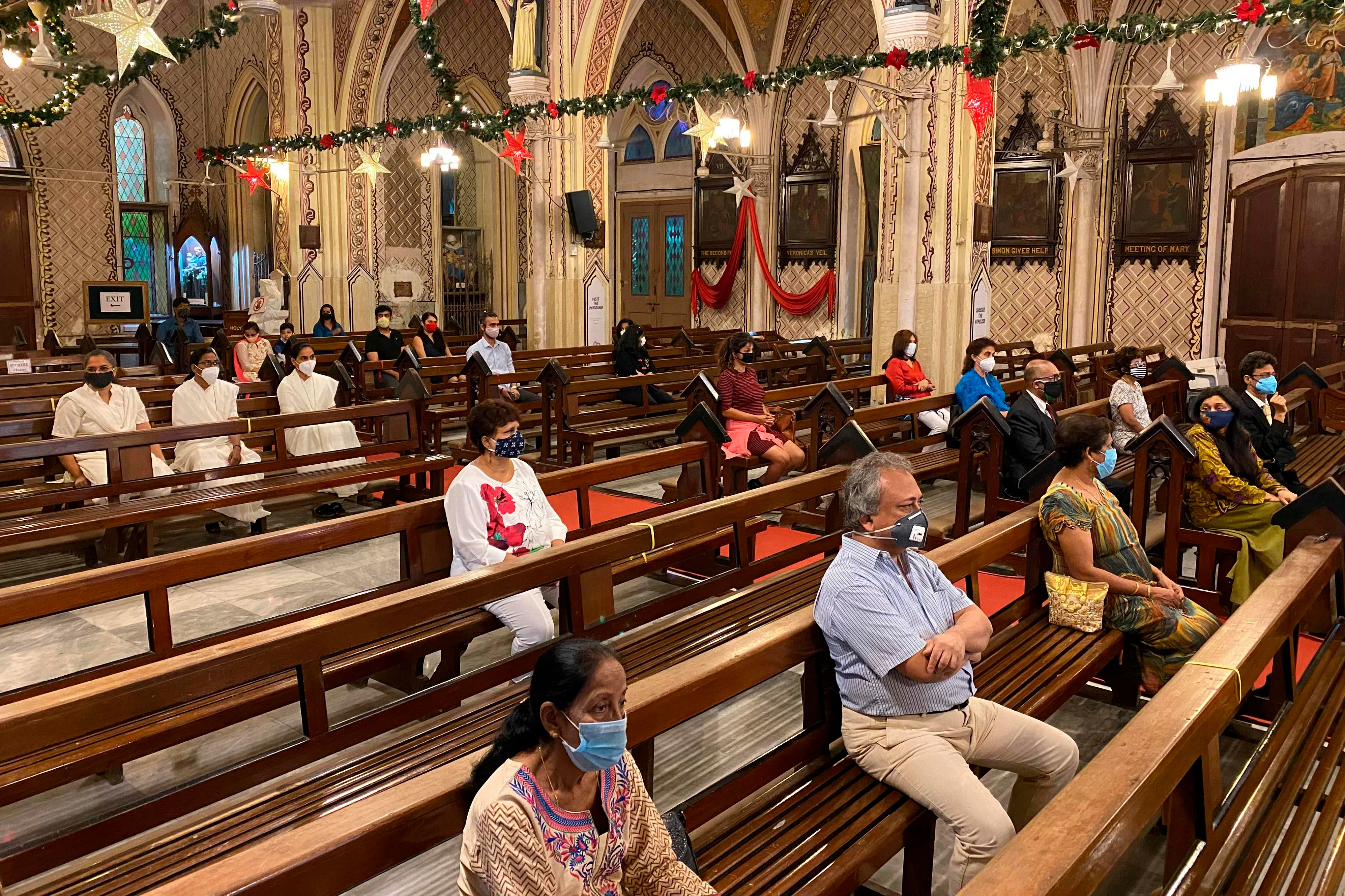 Christian devotees take part in a mass service on the eve of Christmas, in Mumbai on December 24, 2020