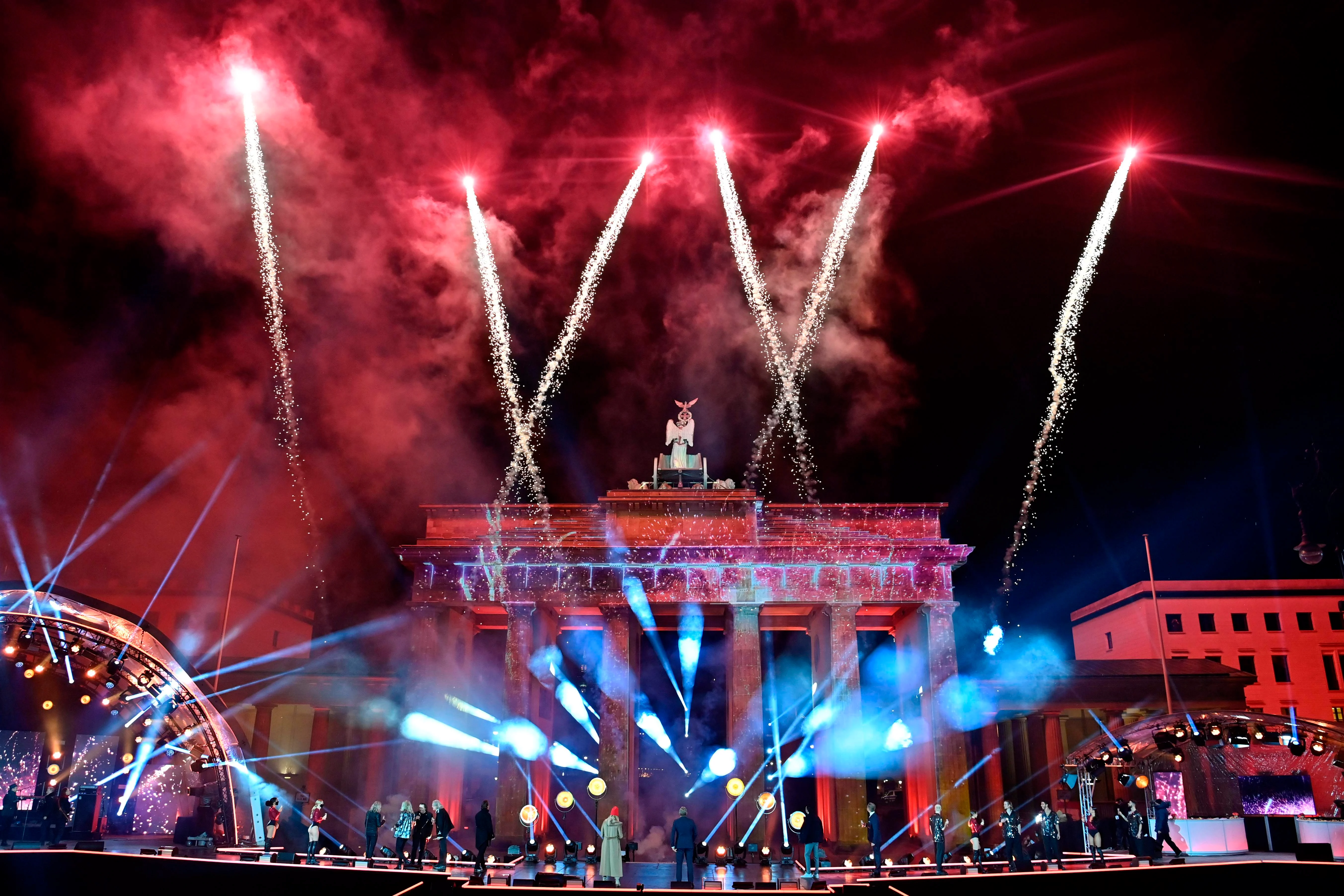 Musicians watch as fireworks explode over Berlins landmark Brandenburg Gate to usher in the new year during a concert Willkommen 2021 (Welcome 2021) on January 1, 2021.
