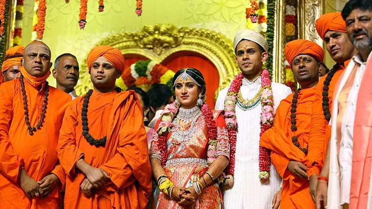 State Congress chief DK Sivakumar with daughter Aishwarya and son in law Amartya Hegde gets clicked during the marriage ceremony