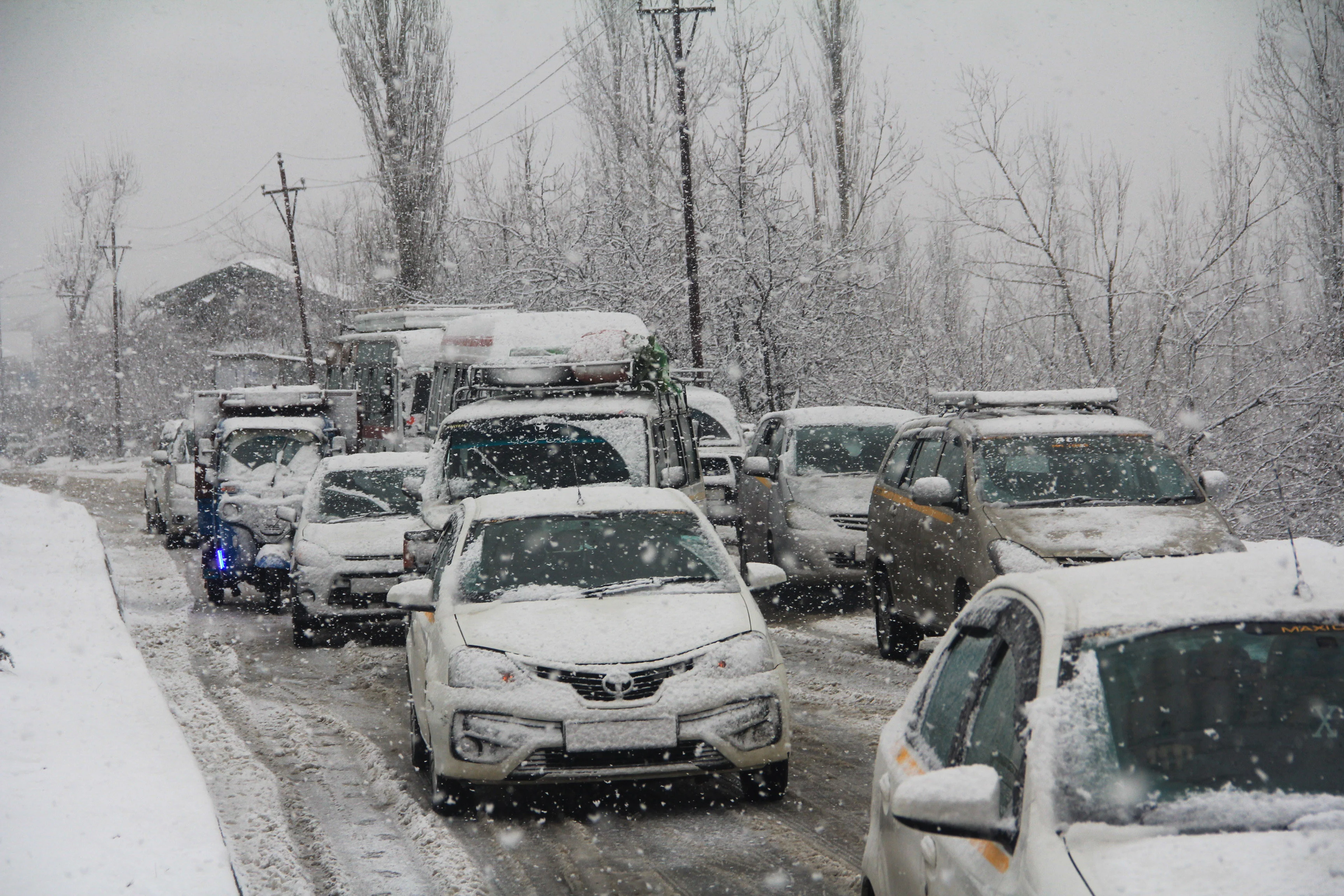 Vehicles stranded on the snow-covered road in Tangmarg area of Kashmir.