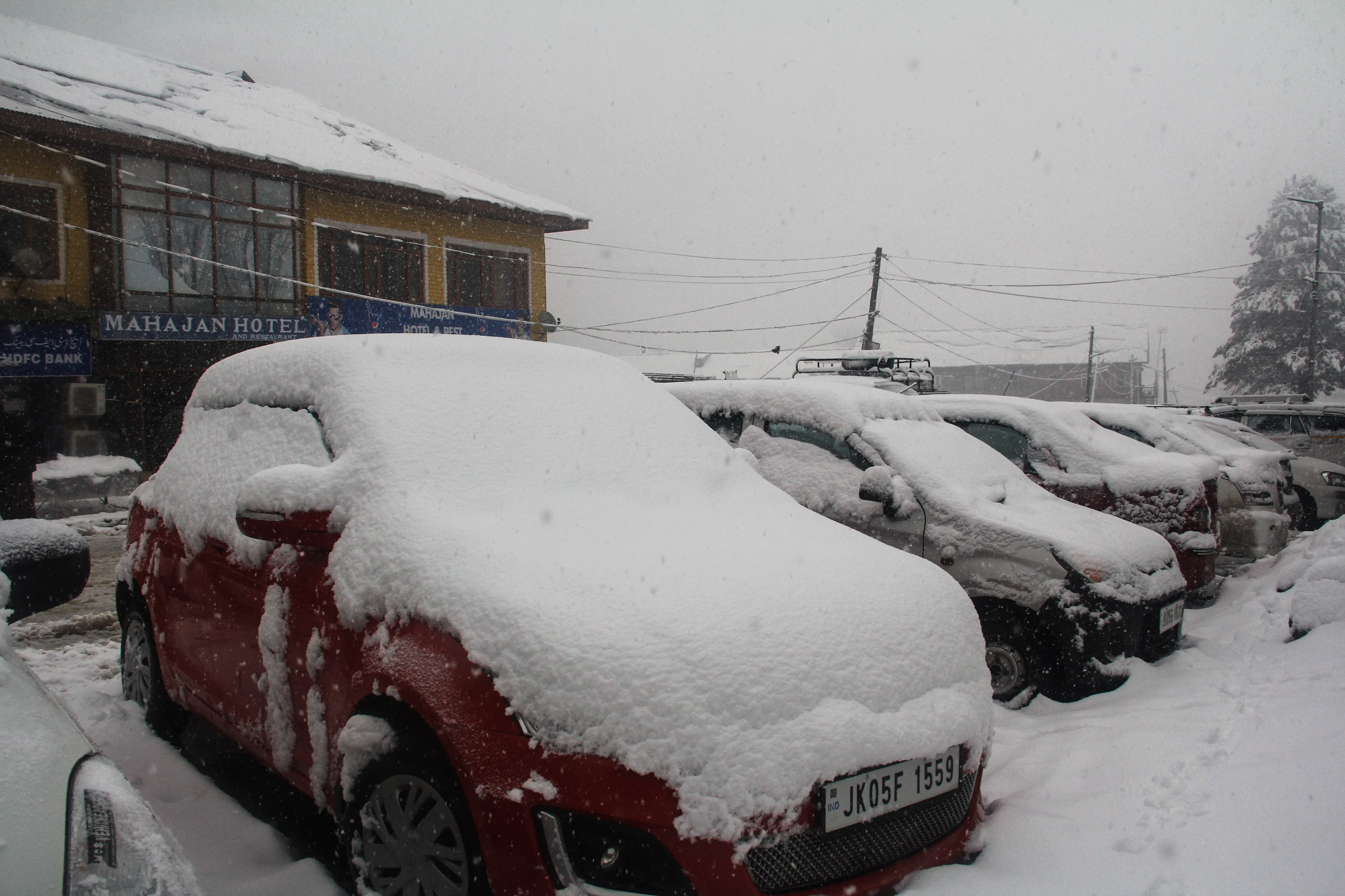 Vehicles stranded on the snow-covered road in Tangmarg area of Kashmir.
