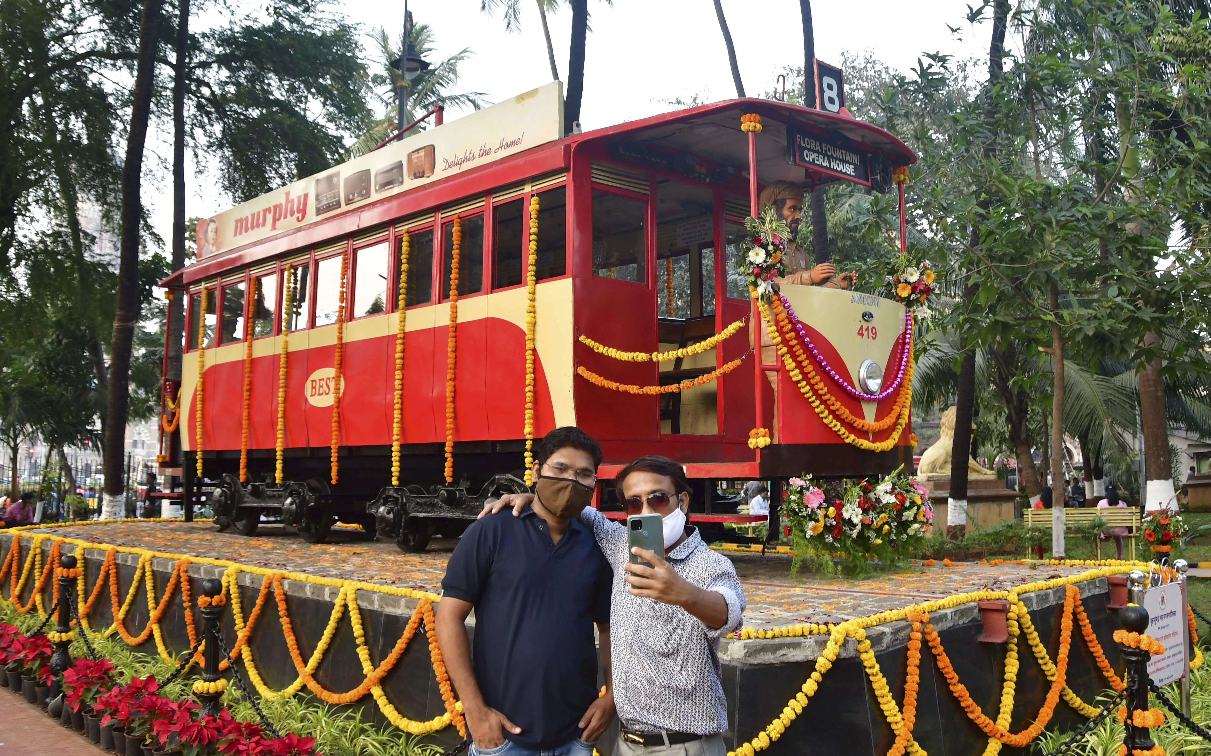 Mumbai: Visitors click selfies in front of a century-old tram bogie, inaugurated by BMC, at Bhatia Baug near CSMT in Mumbai, Thursday, Feb. 25, 2021.