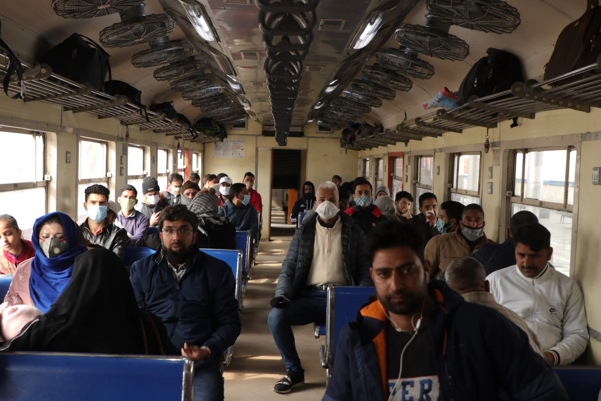 Passengers board a train as the rail service connecting Banihal to Baramulla resumed, in Kashmir on monday. After remaining suspended for 11 months due to the pandemic.