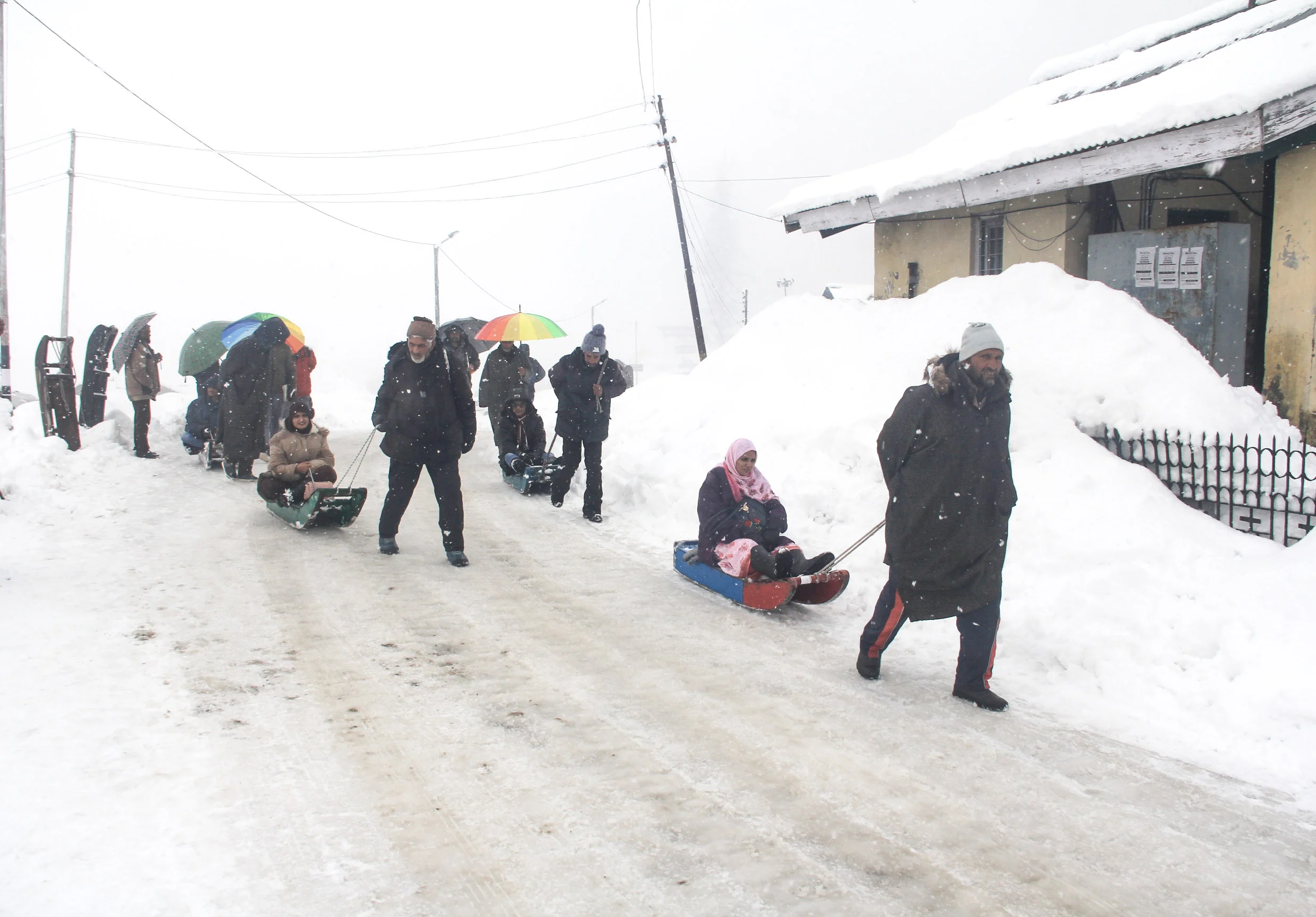 Tourists take sledge ride during fresh snowfall in Ski Resort Gulmarg, Kashmir.