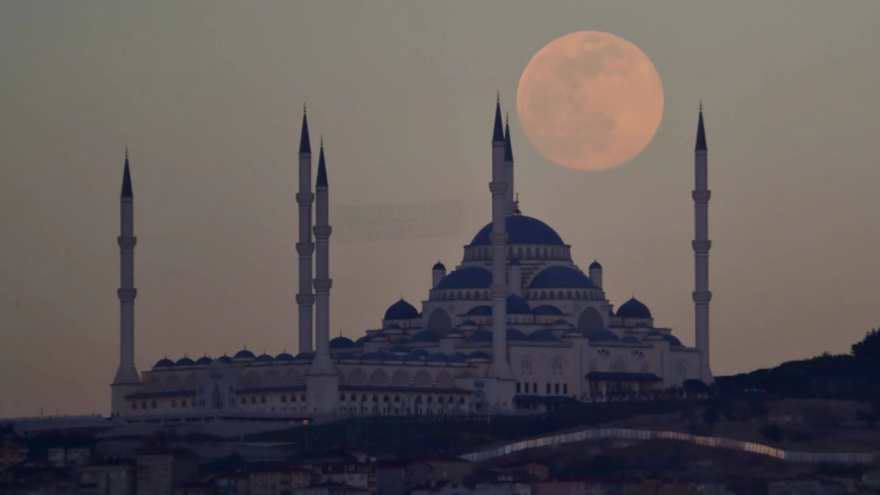 Supermoon rises above Camlica mosque in Istanbul.