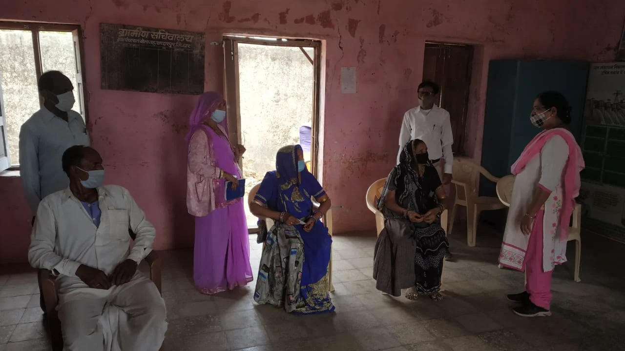 People waiting for turn to get vaccinated at vaccination centre in Sardarpur village of Dhar district on Monday