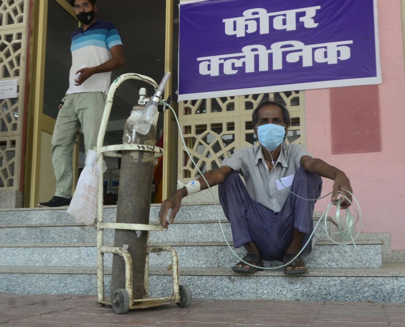 Bhagwandas, a TB patient on oxygen support, moves from pillar to post to get himself Covid-tested at Hamidia Hospital on Friday.