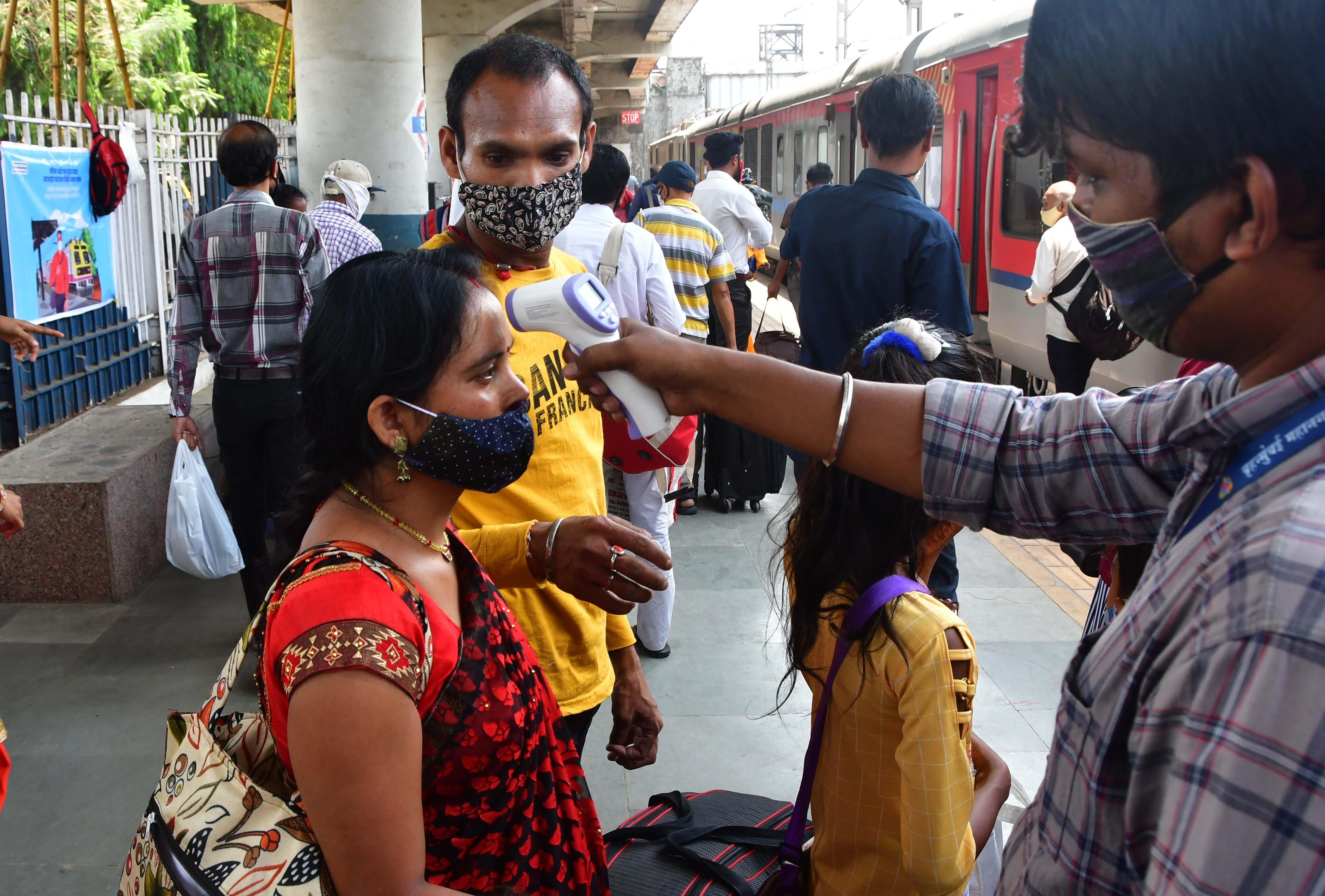 Mumbai: A health worker screening of a passenger at a Dadar railway station during weekend lockdown restrictions imposed by the state government amidst rising Covid-19 coronavirus cases, at Dadar, in Mumbai on Sunday, April 11, 2021. 