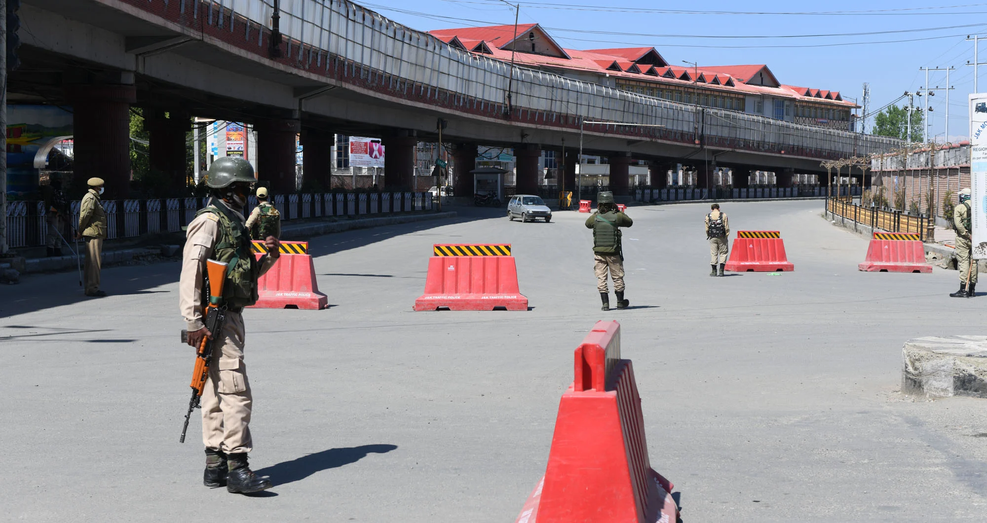 Paramilitary personnel stand guard at a deserted street during a weekend curfew imposed in Srinagar, Kashmir, amid a countrywide spike in coronavirus cases.