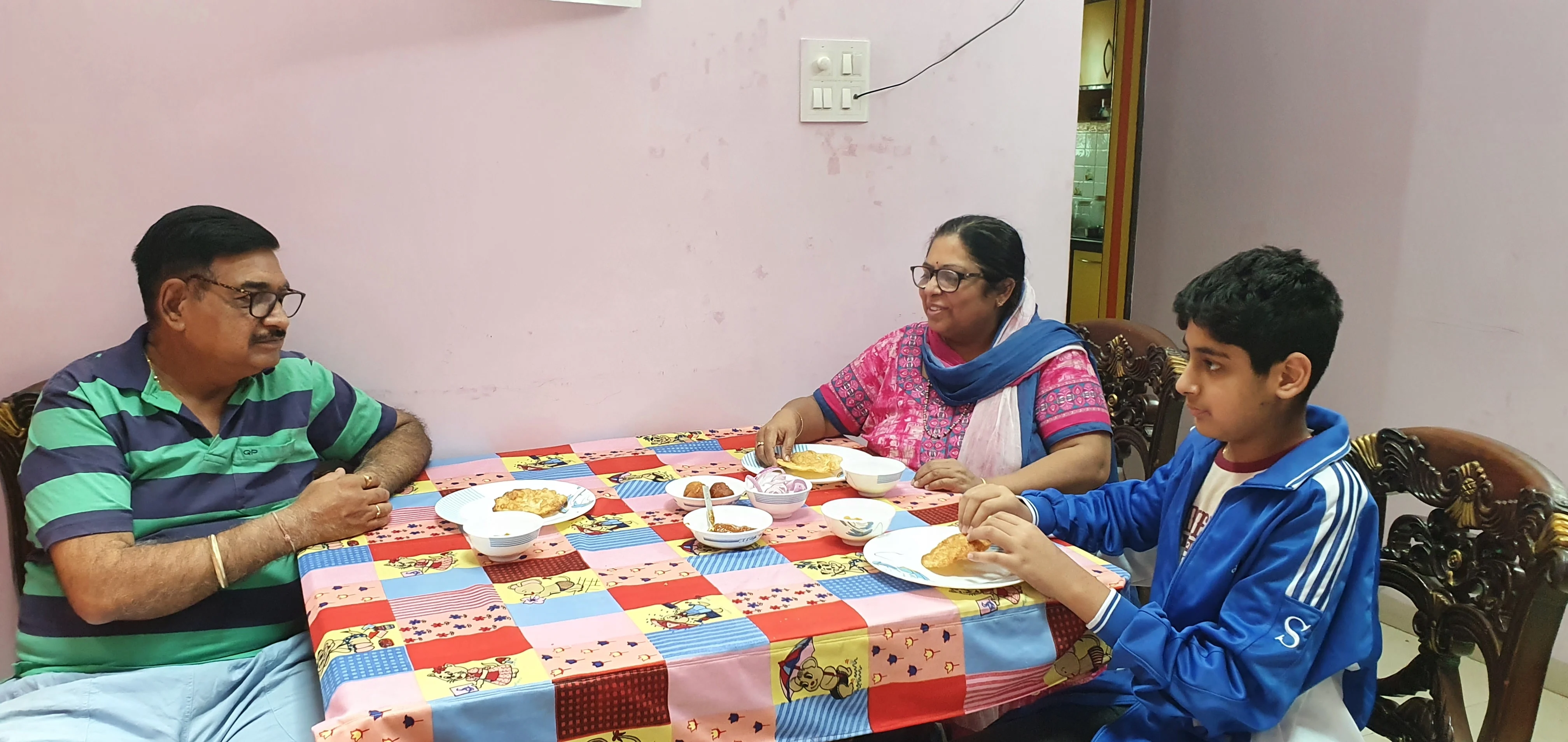 A Sindhi family enjoying Dal Pakwan at their house in Indore on Sunday