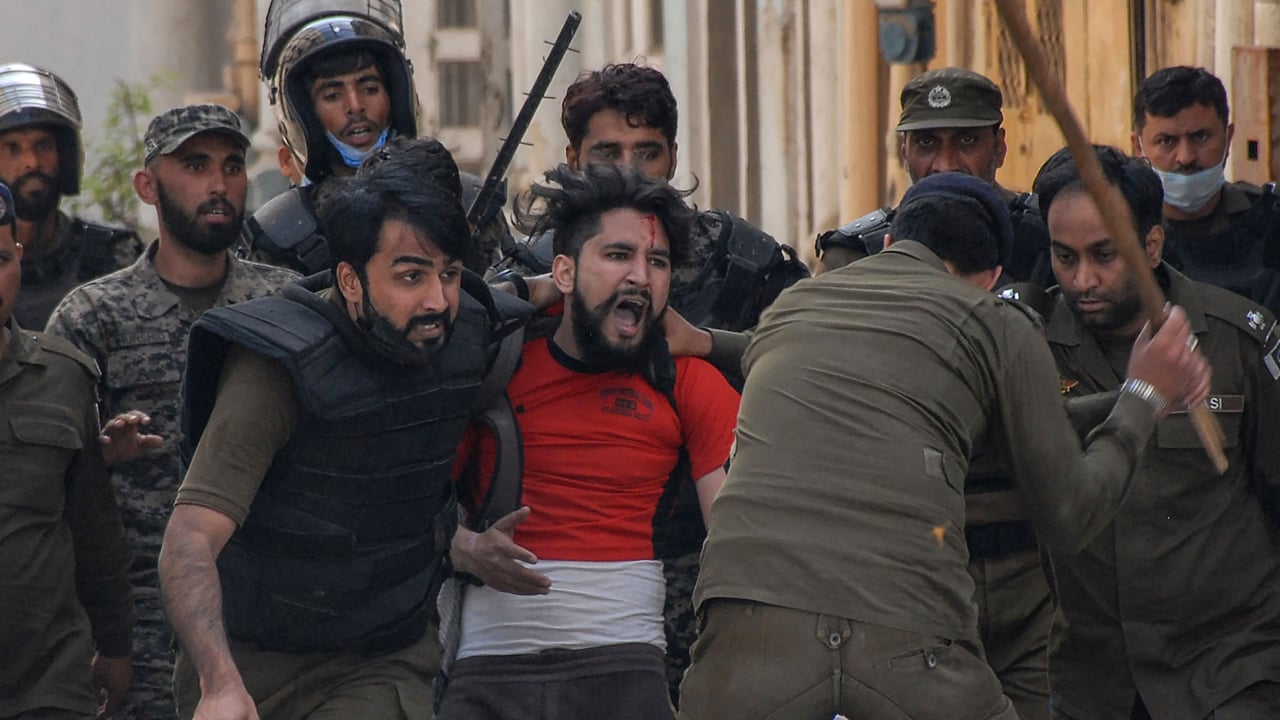 Policemen detain a supporter of Tehreek-e-Labbaik Pakistan (TLP) party during a protest against the arrest of their leader as he was demanding the expulsion of the French ambassador over depictions of Prophet Muhammad, in Rawalpindi on April 14, 2021.
