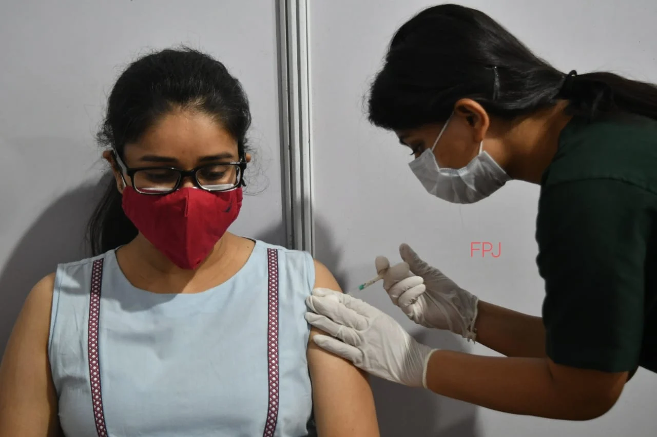A beneficiary receives a dose of COVID-19 vaccine amid the rise in coronavirus cases.