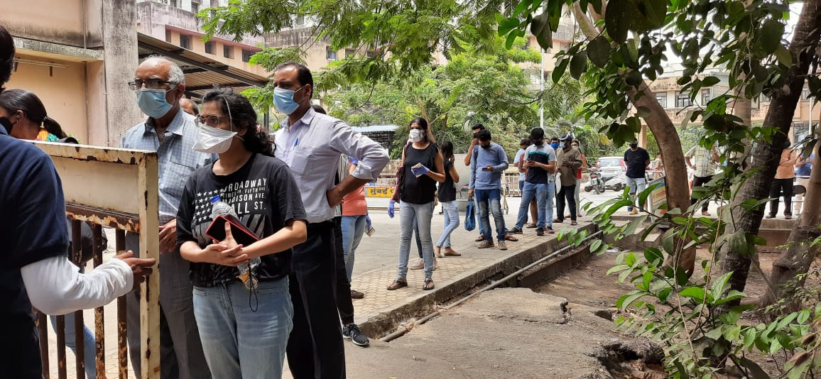 People wait for a dose of the Covid-19 coronavirus vaccine at a vaccination centre in Mumbai on May 1, 2021 during the first day of India's vaccination drive to all adults.