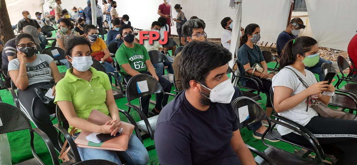 People wait for a dose of the Covid-19 coronavirus vaccine at a vaccination centre in Mumbai on May 1, 2021 during the first day of India's vaccination drive to all adults.