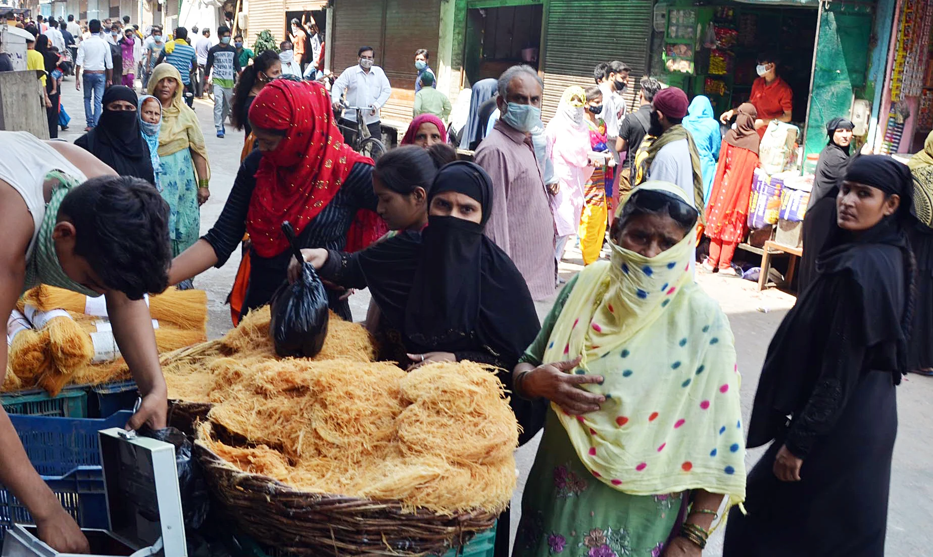 Women purchase Sewaiyan ahead of Eid festival during the lockdown, at a market in Mathura on Tuesday.