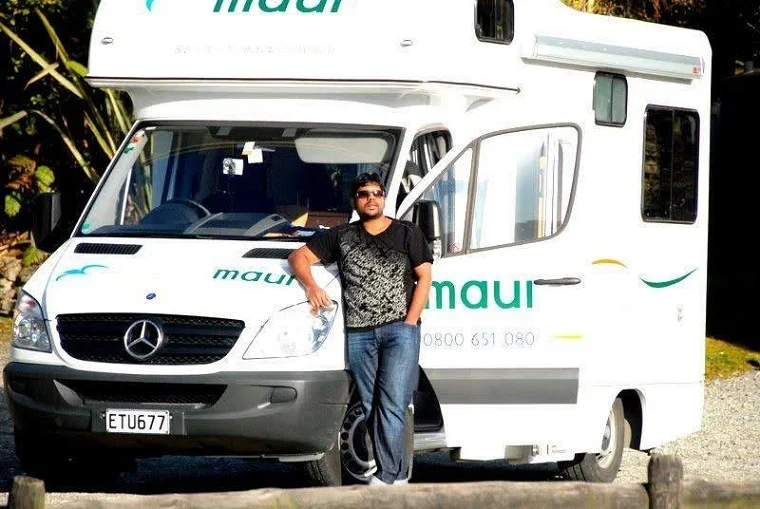 Karthik Tann travelling and working in New Zealand, in South Island. Here, he is seen in the Milford Sound Area