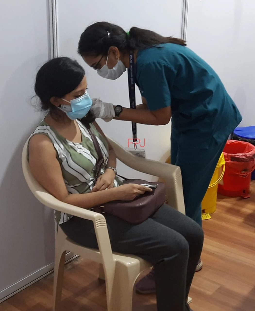 A beneficiary receives a dose of COVID-19 vaccine amid the rise in coronavirus cases.