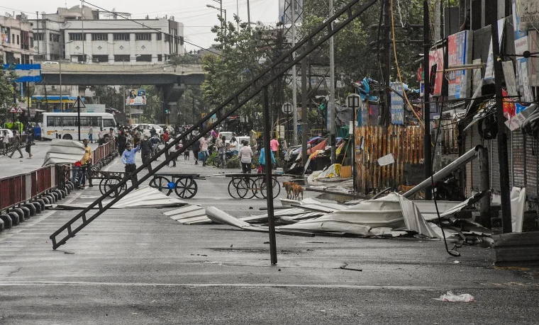 Tin sheets lie on a road after being detached from the roofs of a few shops due to strong winds, induced by Cyclone Tauktae in Surat