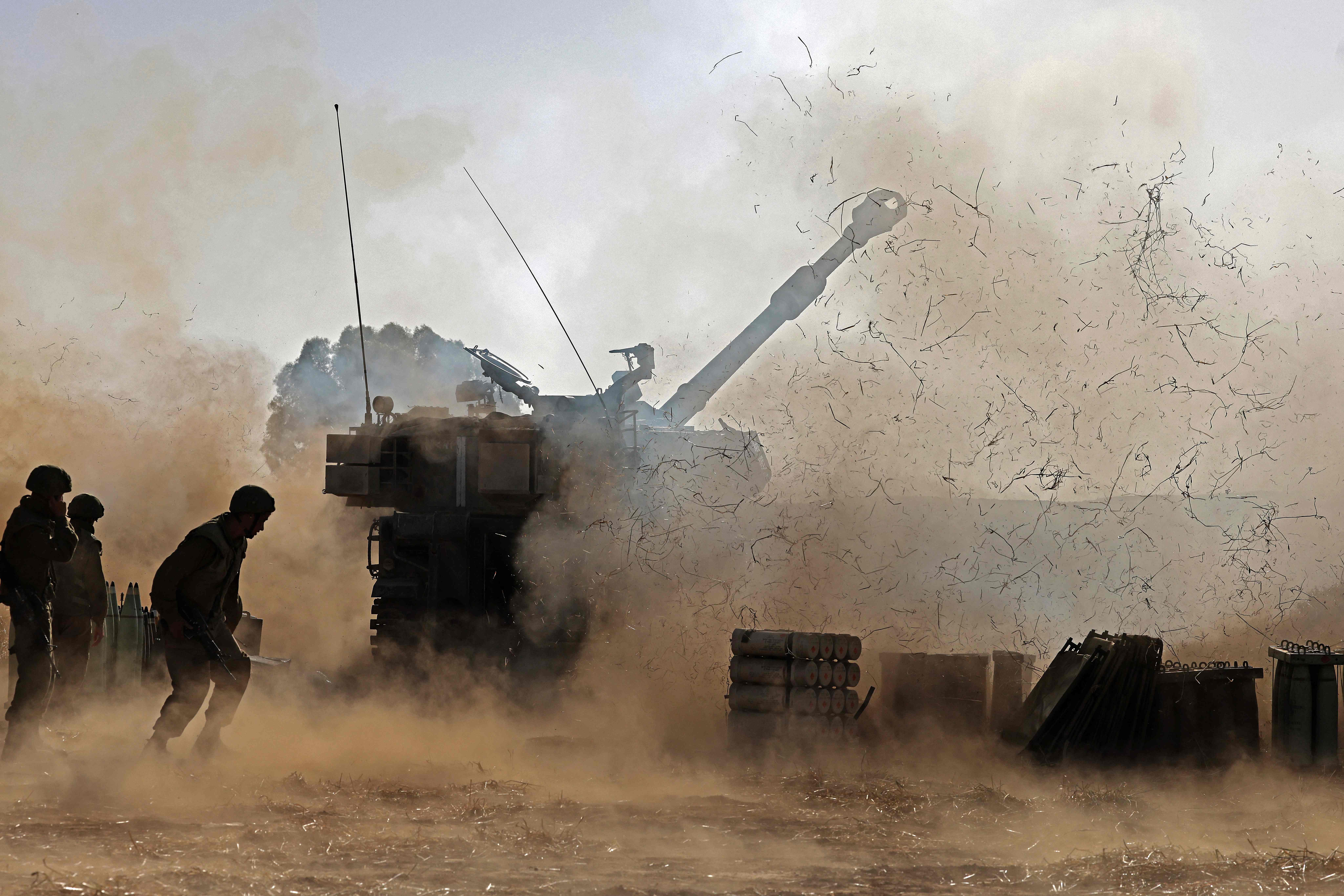 Israeli soldiers fire a 155mm self-propelled howitzer towards the Gaza Strip from their position near the southern Israeli city of Sderot on May 12, 2021. - Israels Defence Minister Benny Gantz vowed more attacks on Hamas and other Palestinian militant groups in Gaza to bring "total, long-term quiet" before considering a ceasefire.