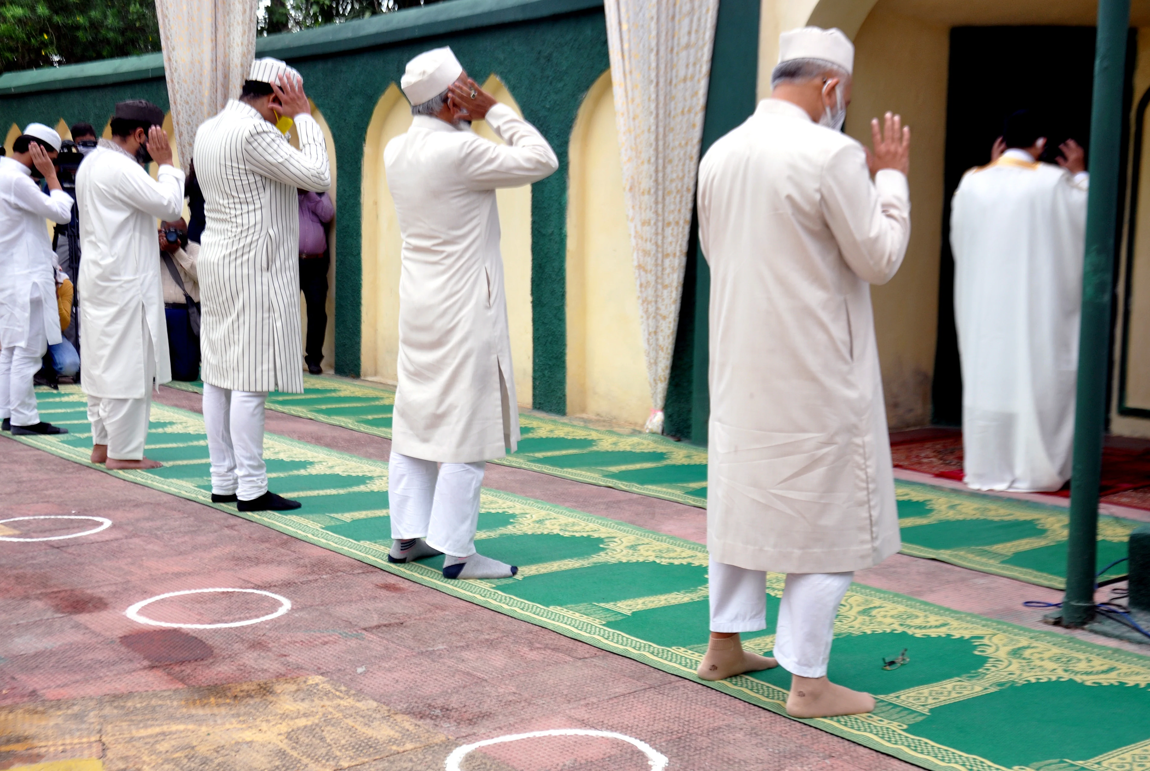 Imam of Aishbagh Eidgah Maulana Khalid Rashid Firangi Mahali along with Muslim devotees perform prayer on the occasion of Eid ul-Fitr festival marking the end of the holy fasting month of Ramadan in Lucknow on Friday.
