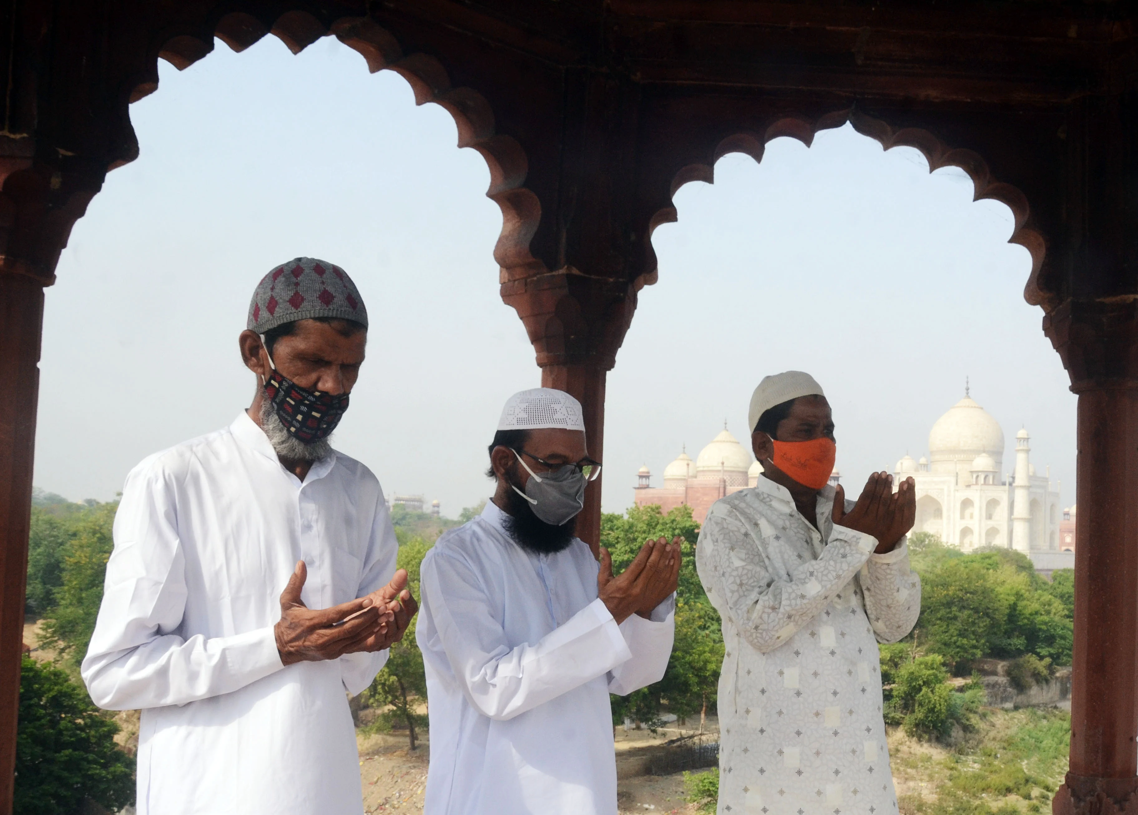 Muslim devotees offer prayers during the Eid-ul-Fitr festival marking the end of the holy fasting month of Ramadan, near Taj Mahal in Agra on Friday.