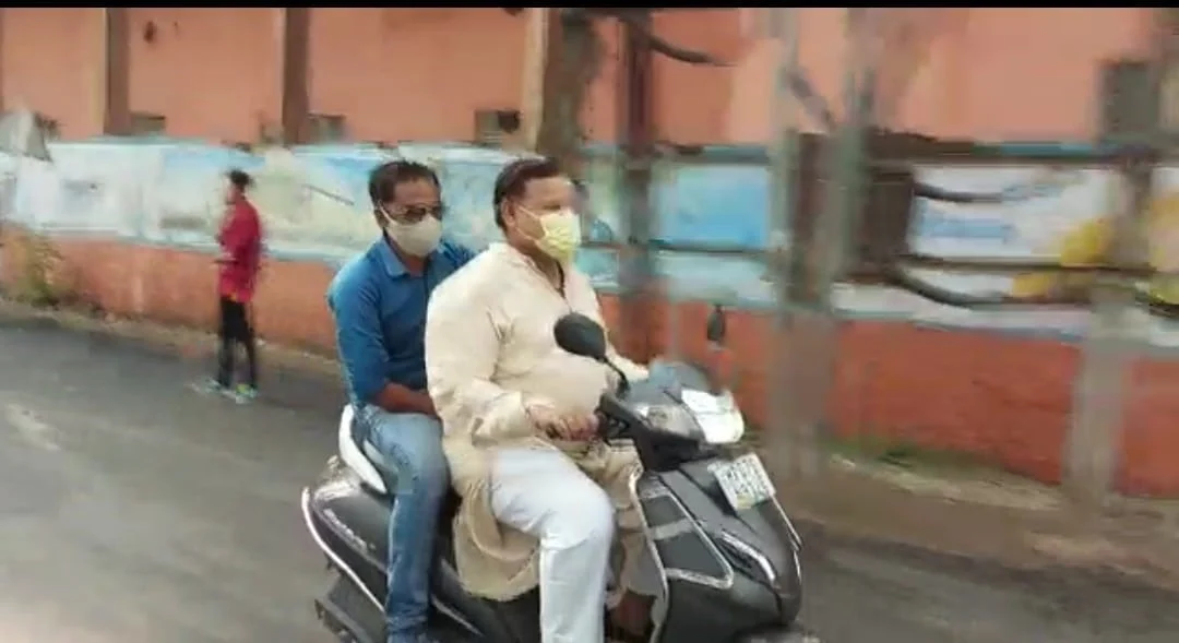 State energy minister Pradhuman Singh Tomar riding a two wheeler without wearing a helmet in Gwalior on Friday.