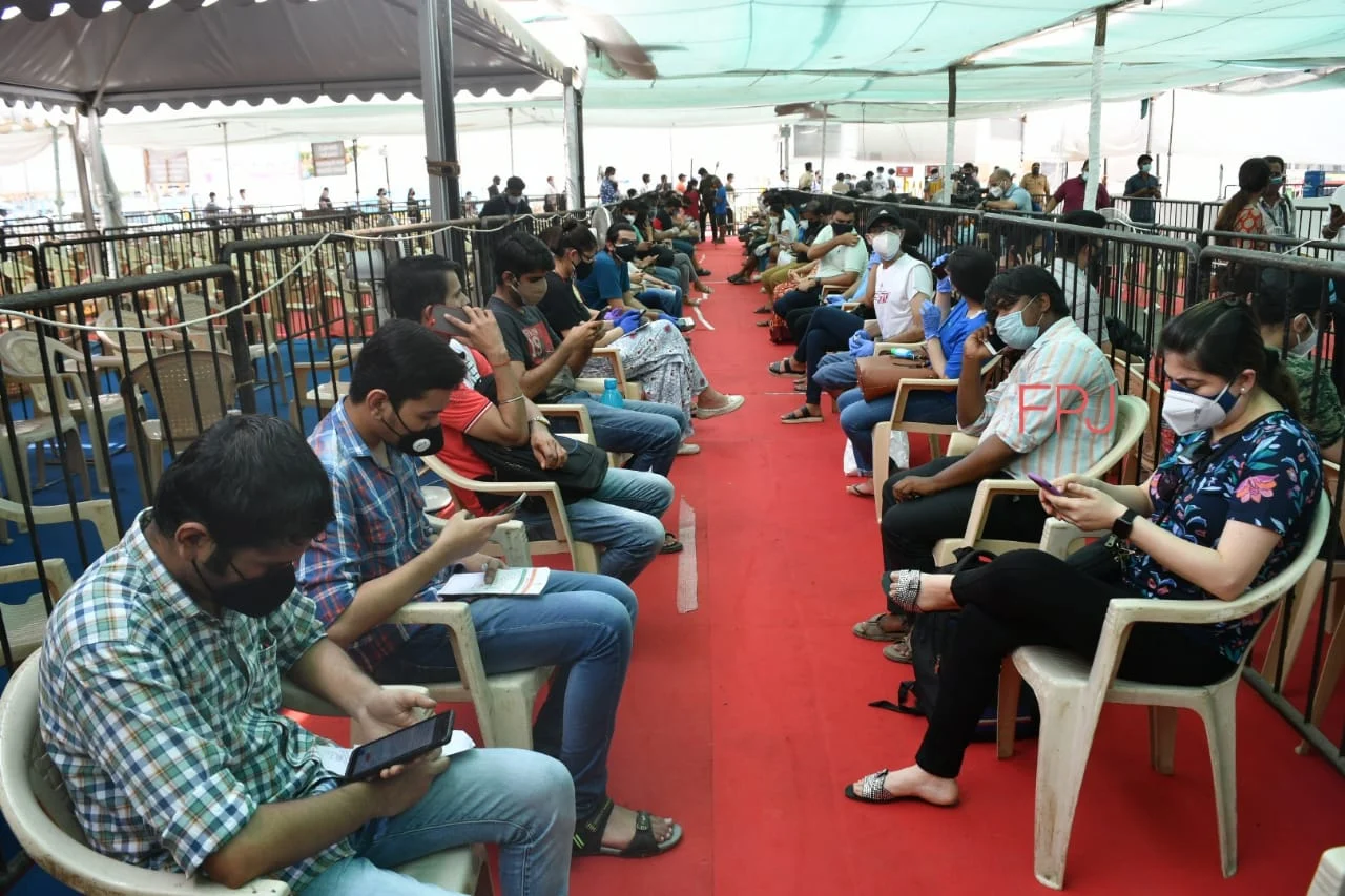 People wait for a dose of the Covid-19 coronavirus vaccine at a vaccination centre in Mumbai on May 1, 2021 during the first day of India's vaccination drive to all adults.