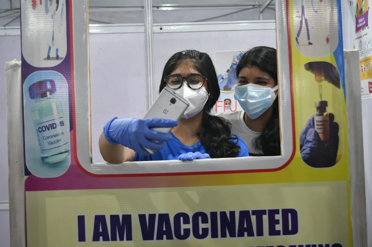 A beneficiary clicking selfie at a selfie booth on COVID-19 vaccination centre.