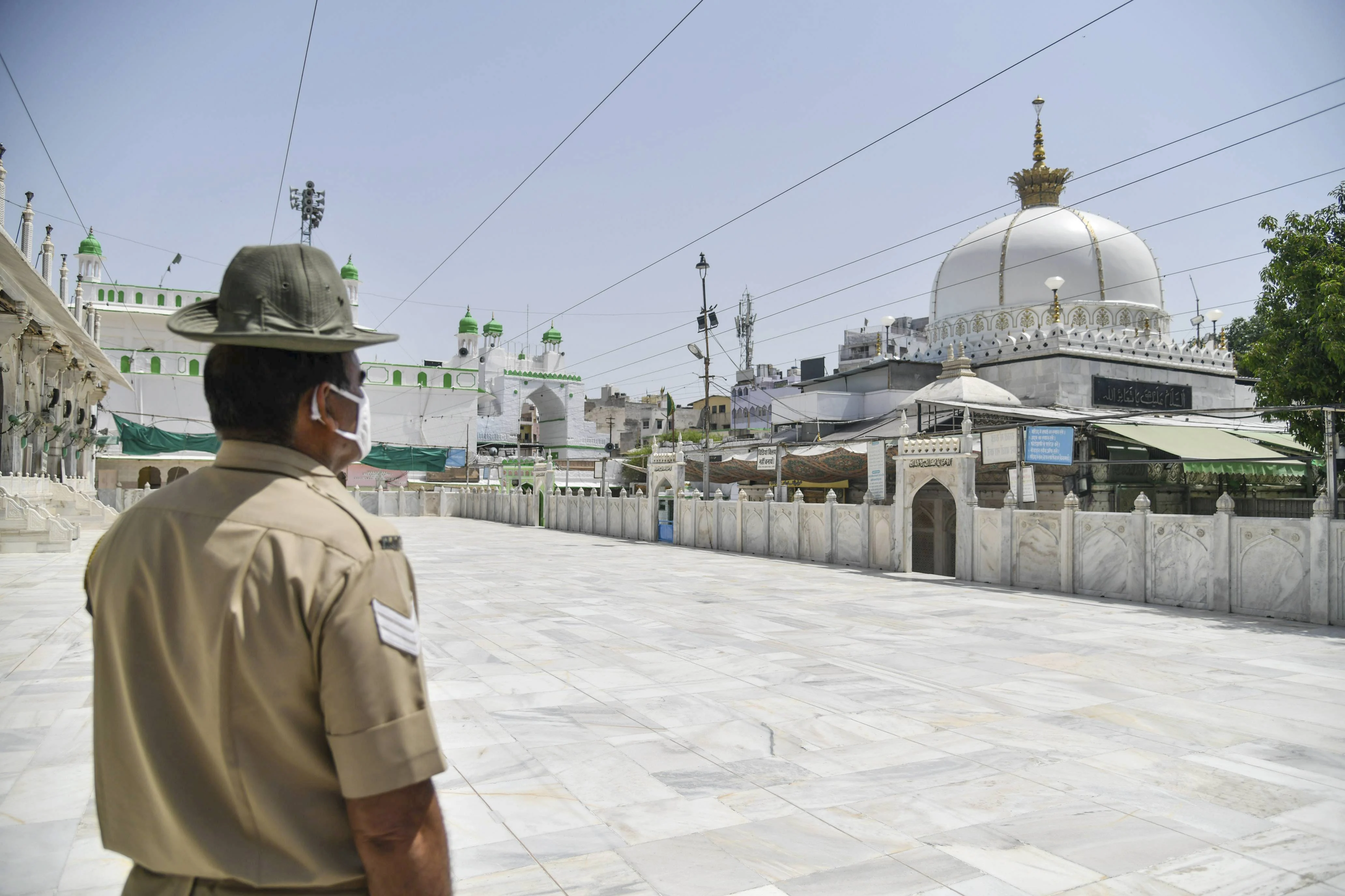 A policeperson stands guard outside a dargah on the occasion of Eid ul-Fitr, marking the end of holy fasting month of Ramadan, during the ongoing COVID-induced lockdown, in Ajmer, Friday, May 14, 2021.